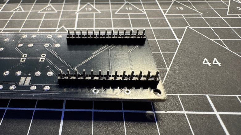 Placed header pins on PCB (longer legs through PCB)
